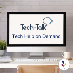 Computer monitor on a desk displaying the Tech-Talk logo and text, "Tech Help on Demand"