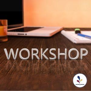 Desk , computer, notebook and pen with decorative text Workshop