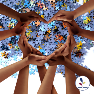 Background of jigsaw puzzle pieces and hands forming a heart in front of image