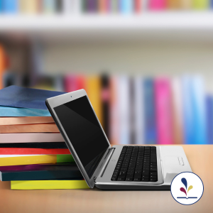 Laptop computer and stacks of books