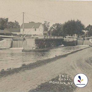 Erie Canal with locks, waterfalls and dirt path alongside the canal