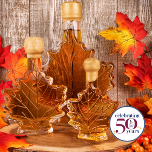 Bottles shaped like maple leaves  of maple syrup and fall leaves