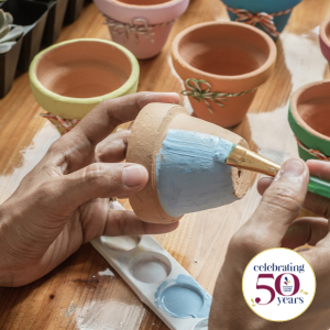 Clay flower pots being painted