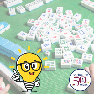 Graphic of lightbulb with glasses and Mahjong game in background