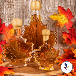 Three maple syrup bottles and maple leaves