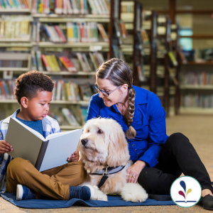 Child reading a book with dog and adult listening