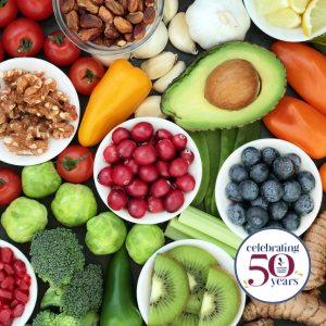 Bowls of berries, an avocado, grapes, kiwi